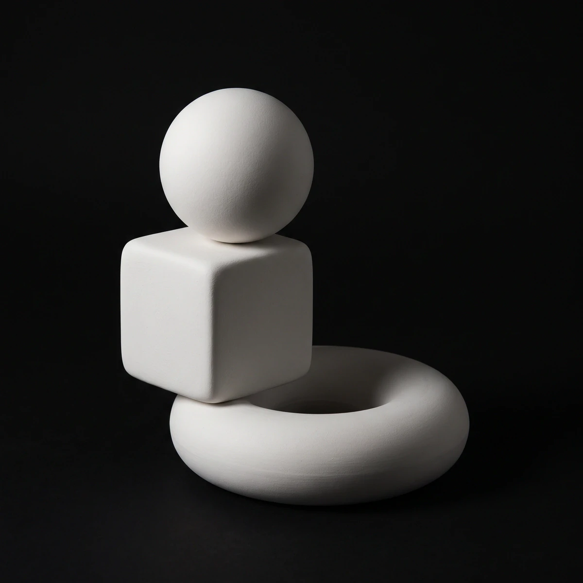 Porcelain sculpture of a sphere, a cube and a torus